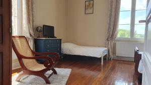 1 dormitorio con cama, escritorio y silla en Domaine De l'Ourbise, 