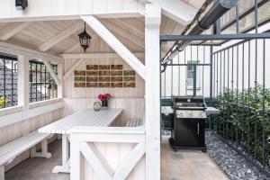 an outdoor kitchen with a table and a stove at Vila Mignon in Bled