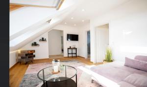 a living room with a couch and a table at Ferienwohnung Untersbergblick in Salzburg