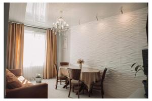 a dining room with a table and a wall with waves at Family apartment in Batumi