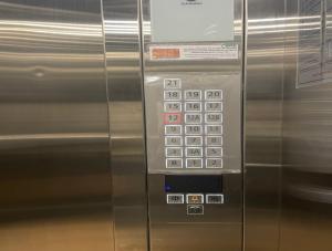 a metal refrigerator with a bunch of buttons on it at Compass One Building - Luxury Apartments in Ấp Phú Thọ