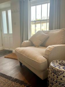 a living room with a couch and a window at Wesley Cottage in Middleham