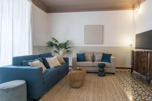 a living room with a blue couch and a chair at Easylife - Lussuosa dimora in Porta Romana in Milan