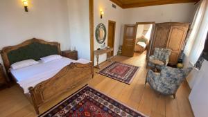 a bedroom with a bed and a chair and a rug at Quiet Abana in Abana