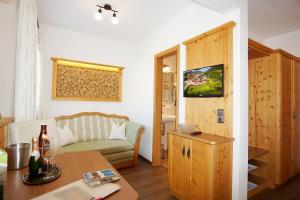 a living room with a table and a couch at Schneider-Hof in Ruhpolding