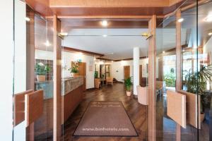 an office lobby with a welcome mat on the floor at Hotel Flora Möhringen in Stuttgart