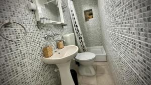 a small bathroom with a sink and a toilet at Villa Casaviva in Komiža
