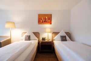 Rúm í herbergi á Hotel Flora Möhringen