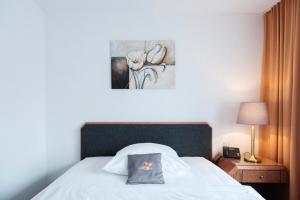 Rúm í herbergi á Hotel Flora Möhringen