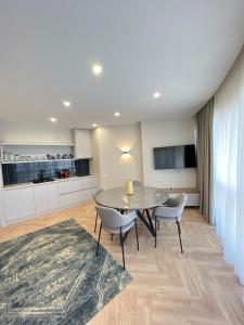 a kitchen and dining room with a table and chairs at Holiday Premium Apartments Batumi in Batumi