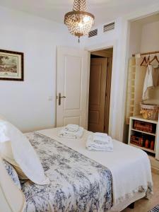 a bedroom with a bed and a chandelier at Remarkable 3-Bed Apartment in Carboneras in Almería