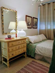 a bedroom with a bed and a dresser with a mirror at Remarkable 3-Bed Apartment in Carboneras in Almería