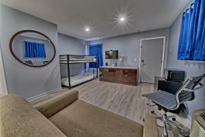 a living room with a couch and a mirror at Aqua View Motel in Panama City Beach