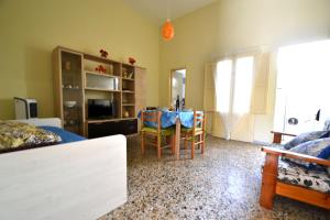 a living room with a table and a dining room at Luce holiday home with air conditioning for 5 guests in Roca Vecchia