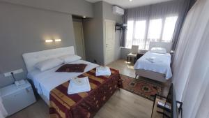 Postel nebo postele na pokoji v ubytování MEHMET BEY HOTEL