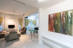 a living room with a large painting on the wall at Penang Balik Pulau Swimming Pool BBQ Homestay in Balik Pulau