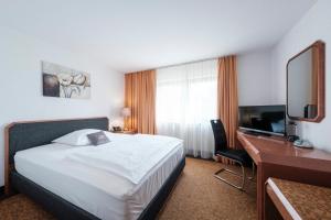 Rúm í herbergi á Hotel Flora Möhringen
