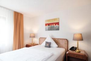 Rúm í herbergi á Hotel Flora Möhringen