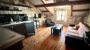a kitchen and a living room with a couch and a table at Villa Casaviva in Komiža +31 photos