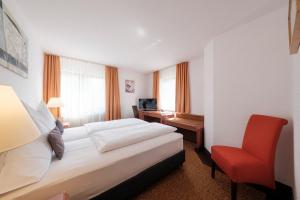Rúm í herbergi á Hotel Flora Möhringen