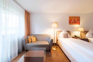 Rúm í herbergi á Hotel Flora Möhringen