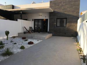 a house with a patio in front of it at Private House 3 bedrooms with garden and terrace - Torre de la Horadada in Torre de la Horadada