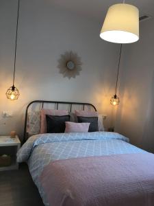 a bedroom with a large bed with two lights at Private House 3 bedrooms with garden - Torre de la Horadada in Torre de la Horadada