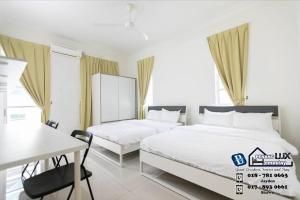 a bedroom with two beds and a table and a desk at Balik Pulau 6BR Comfort Home Villa in Balik Pulau