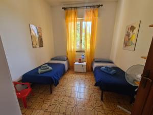 a room with two beds and a window at Scel by PortofinoVacanze in Santa Margherita Ligure