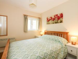 a bedroom with a bed and a window at 15 The Dell in Norwich