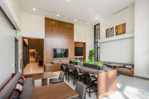 a living room with a long table and chairs at Flats at Cityline in Sunnyvale