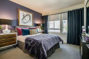 a bedroom with a large bed and a window at Flats at Cityline in Sunnyvale