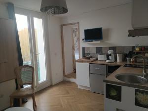 a kitchen with a sink and a counter top at la maison de josy in Aix-en-Provence