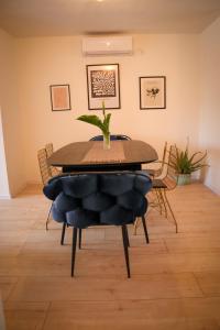 a dining room table with a plant on top of it at Sunny House in Čapljina