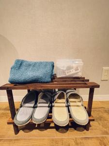 a wooden table with shoes and a blue towel on it at 东京中心 新装修温馨宽敞公寓 202交通方便两条地铁直达上野新宿东京 in Tokyo
