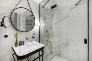 a bathroom with a sink and a mirror and a shower at Hotel Vinifera Wine & Spa 5 Stars Superior in Balatonfüred