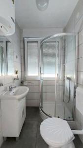 a bathroom with a shower and a toilet and a sink at Studio Apartment 'Dream' in Šibenik