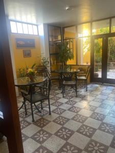 a dining room with tables and chairs on a tiled floor at La Casa de Zarela in Huaraz