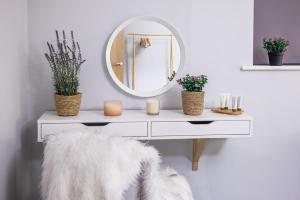 a white dressing table with a mirror and a white stool at Luxury apartment 5 min to city centre*free parking in Newcastle upon Tyne