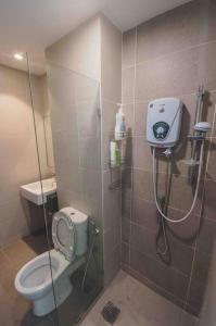 a bathroom with a shower with a toilet and a sink at 3 bedroom condo with Pool near Queensbay Mall in Bayan Lepas