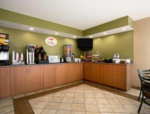 a fast food restaurant with a cash register and a counter at Super 8 by Wyndham Columbia City in Columbia City