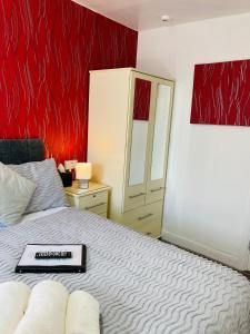 a bedroom with a bed with a book on it at Fairfax in Skegness