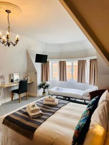 a large bedroom with two beds and a desk at The Silver How in Bournemouth