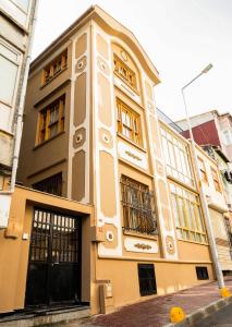 a yellow building with windows on a street at COSA Zeyrek- Home at the heart of Istanbul in Istanbul