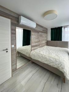 a bedroom with a large bed and a mirror at SOS CoMFORT 2 LAZUR in Burgas