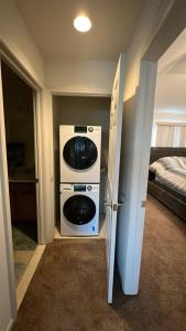 a room with a washer and dryer next to a door at Luxury apartment in suburbs in Sterling Heights