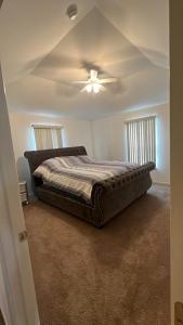 a bedroom with a bed and a ceiling fan at Luxury apartment in suburbs in Sterling Heights