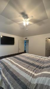 a bedroom with a bed and a ceiling fan at Luxury apartment in suburbs in Sterling Heights