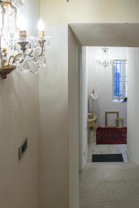 a hallway with a chandelier and a staircase at Alloggi I Calieroni in Valstagna