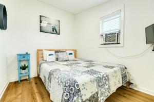 a bedroom with a bed and a window at Cast a Waves - Cute Beach Bungalow - Ocean Views - Walk to the Beach in Galveston